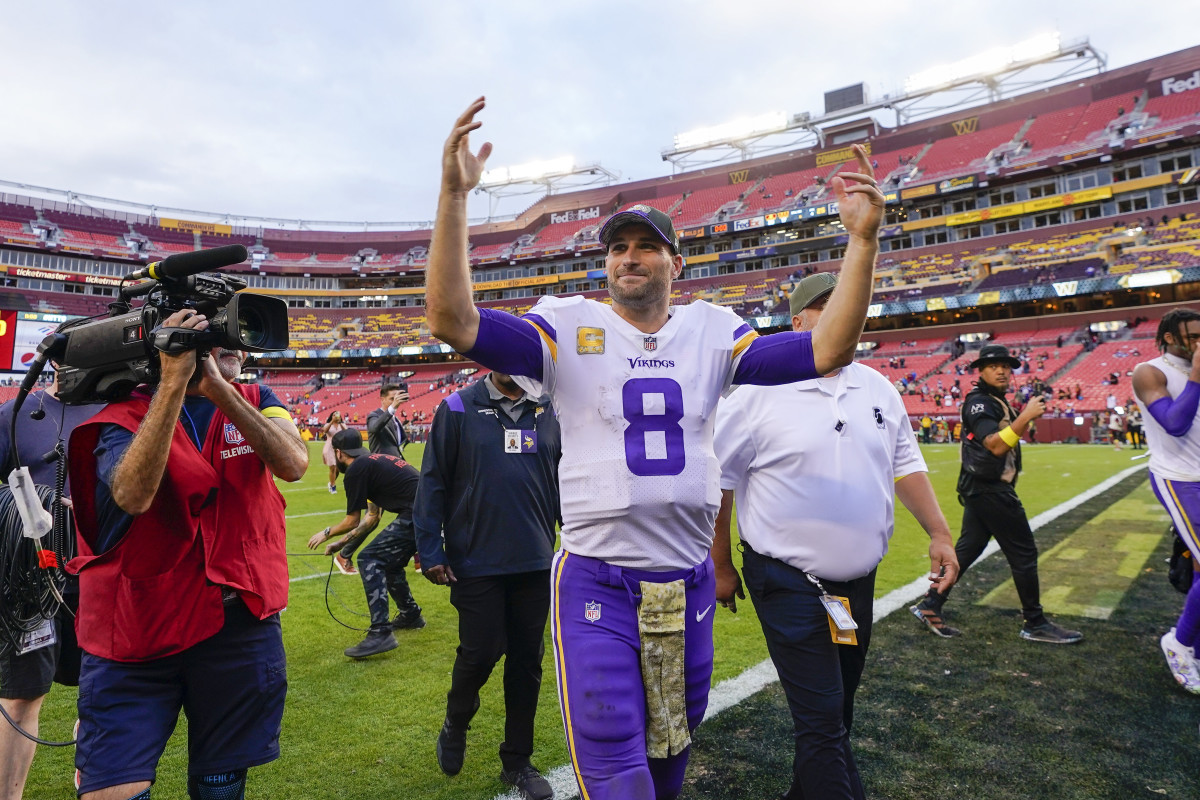 Kirk Cousins smiles and waves to the crowd as he leaves FedEx Field