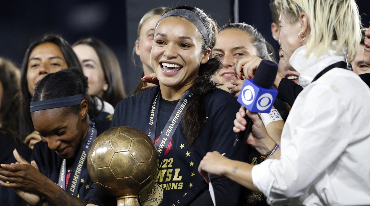 Sophia Smith holds the MVP trophy after the Portland Thorns win the 2022 NWSL championship.