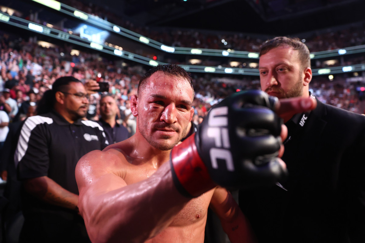 Michael Chandler celebrates his knockout victory against Tony Ferguson during UFC 274 at Footprint Center.