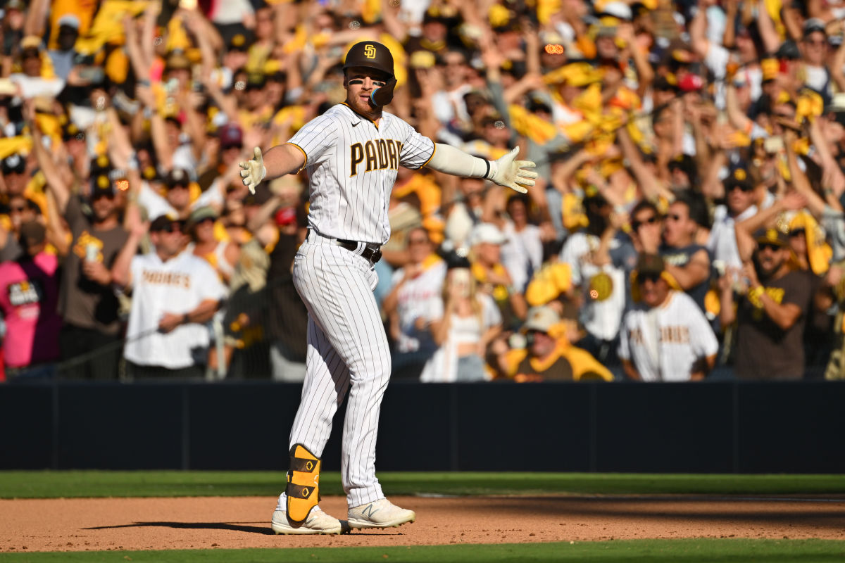 Padres player Brandon Drury puts his arms out in celebration