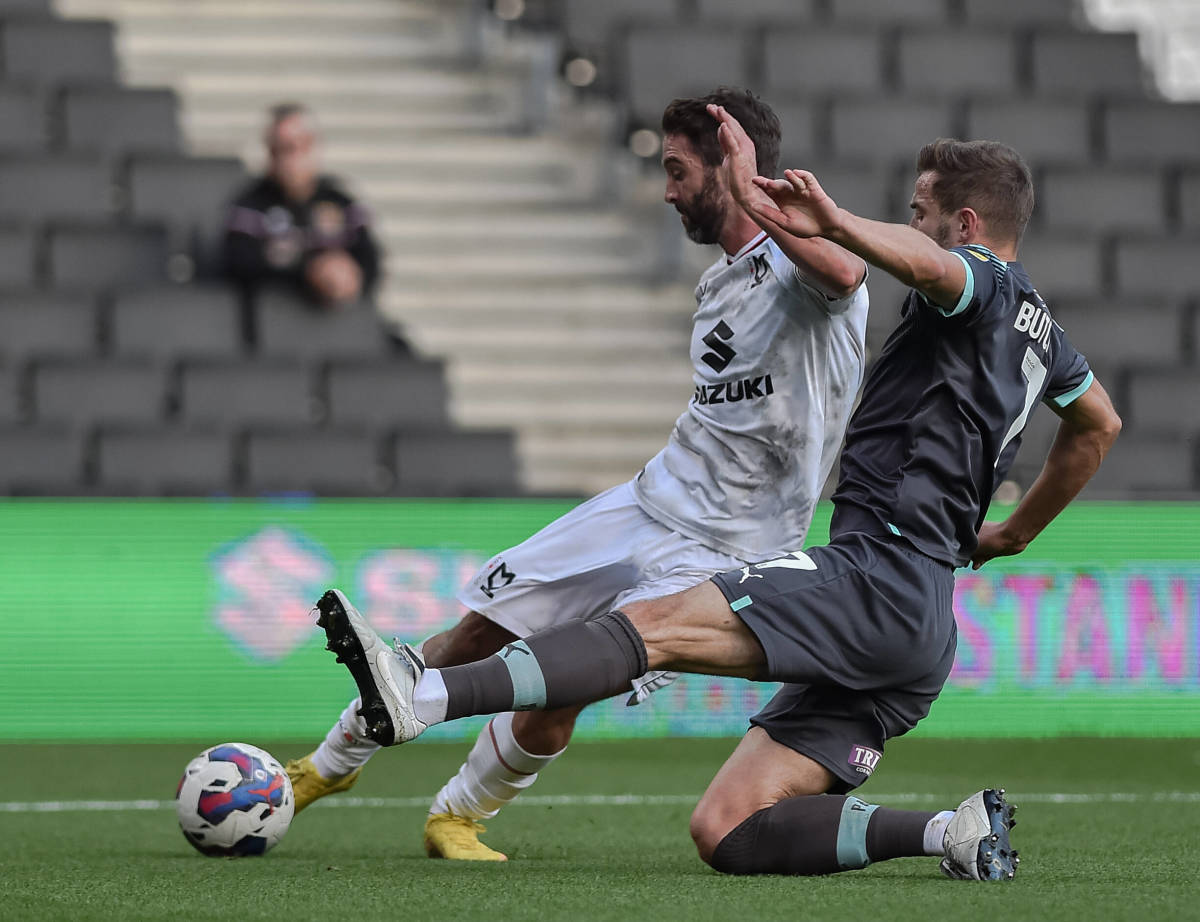Will Grigg in action for MK Dons