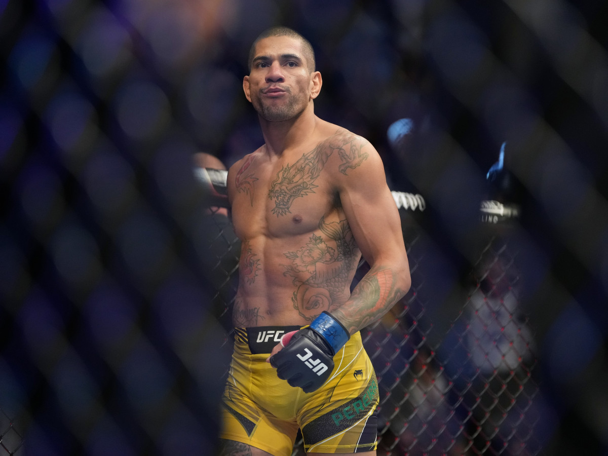 Alex Pereira (blue gloves) reacts after defeating Sean Strickland (red gloves) UFC 276 at T-Mobile Arena.