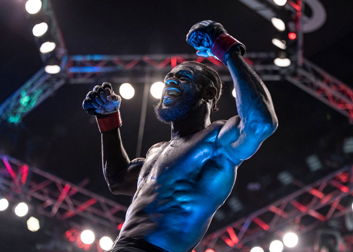 Aljamain Sterling (red gloves) celebrates after defeating T.J. Dillashaw (blue gloves) during UFC 280 at Etihad Arena.