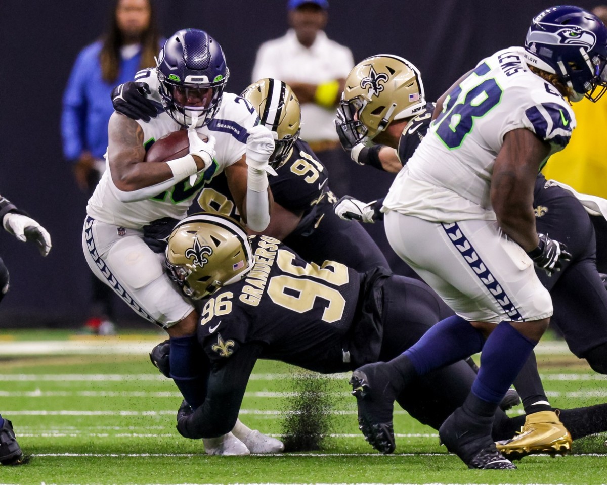 Seattle Seahawks running back Rashaad Penny (20) is tackled by New Orleans Saints defensive end Carl Granderson (96) and defensive tackle Kentavius Street (91). Mandatory Credit: Stephen Lew-USA TODAY Sports