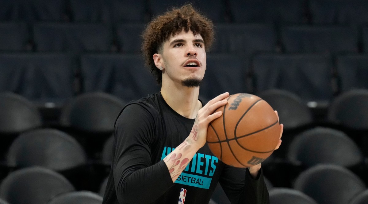 Hornets guard LaMelo Ball shoots during warmups before a game against the Wizards.