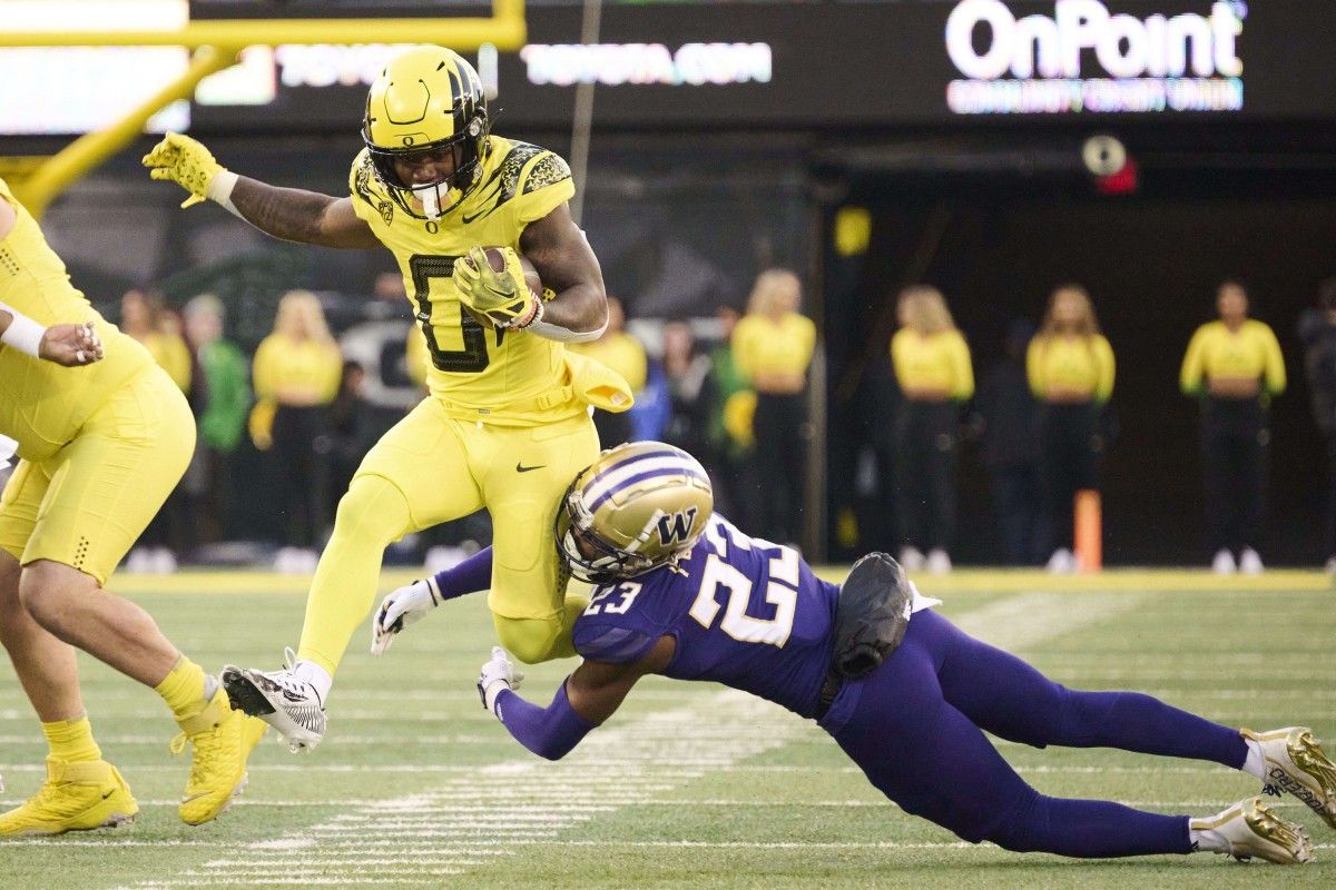 UW cornerback Mishael Powell makes a tackle on Oregon running back Bucky Irving.