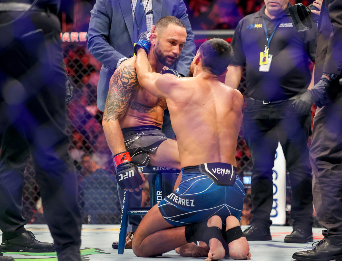 Frankie Edgar (red gloves) is consoled by Chris Gutierrez (blue gloves) after their bout at UFC 281 at Madison Square Garden.