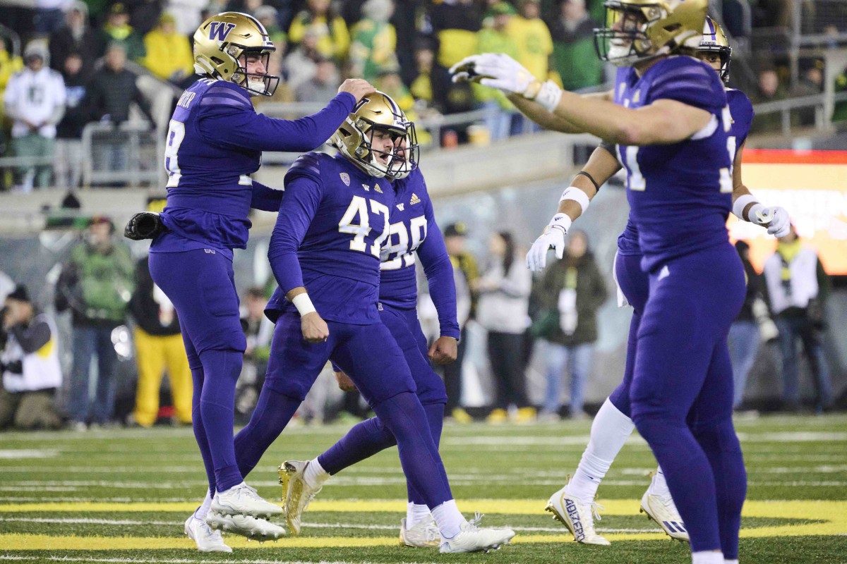 Teammates gleefully congratulate Peyton Henry after his game-winning kick.