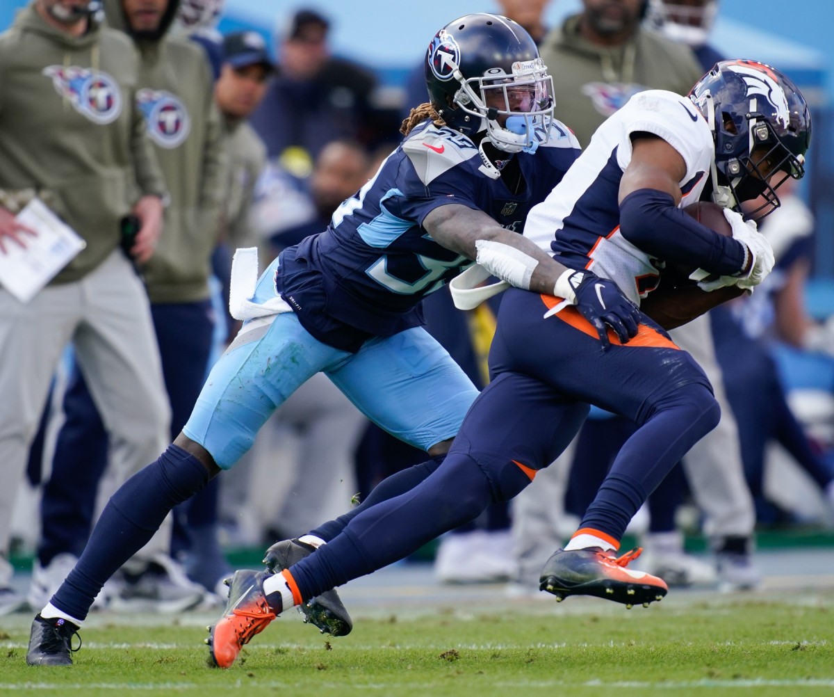 Tennessee Titans cornerback Terrance Mitchell (39) tackles Denver Broncos wide receiver Kendall Hinton (9) during the third quarter at Nissan Stadium.