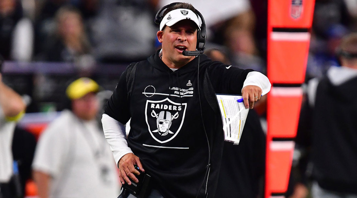 Josh McDaniels gestures along the sideline while coaching the Raiders.