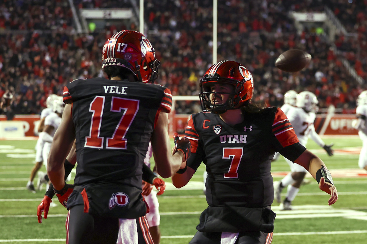Utah Utes wide receiver Devaughn Vele (17) and quarterback Cameron Rising (7) celebrate after a touchdown against the Stanford Cardinal in the second quarter at Rice-Eccles Stadium.