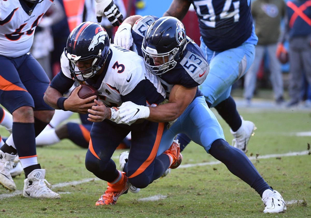 Denver Broncos quarterback Russell Wilson (3) is tackled from behind by Tennessee Titans linebacker Dylan Cole (53) during the second half at Nissan Stadium.
