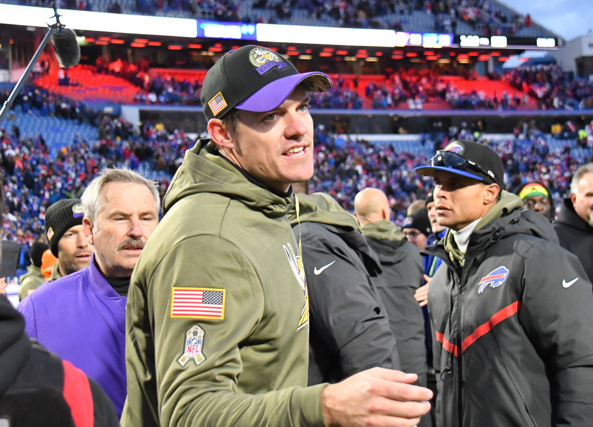 Kevin O'Connell shaking hands on the field after a victory over the Bills