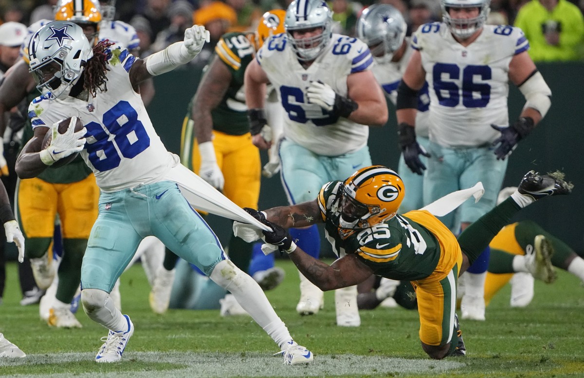 Green Bay Packers cornerback Keisean Nixon (25) tries to tackles Dallas Cowboys wide receiver CeeDee Lamb (88) during the third quarter of their game Sunday, November 13, 2022 at Lambeau Field in Green Bay, Wis. The Green Bay Packers beat the Dallas Cowboys 31-28 in overtime. Packers13 26