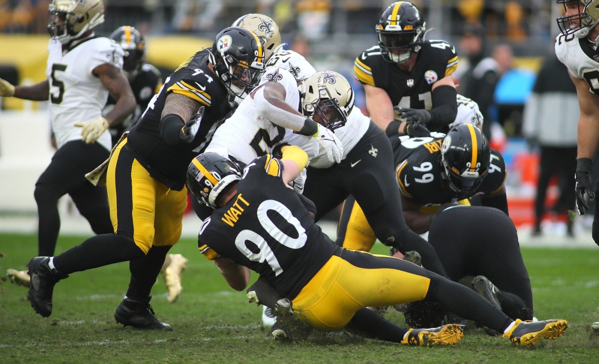New Orleans Saints Jordan Howard (28) gets wrapped up for a tackle in the backfield by Pittsburgh Steelers T.J. Watt (90). 