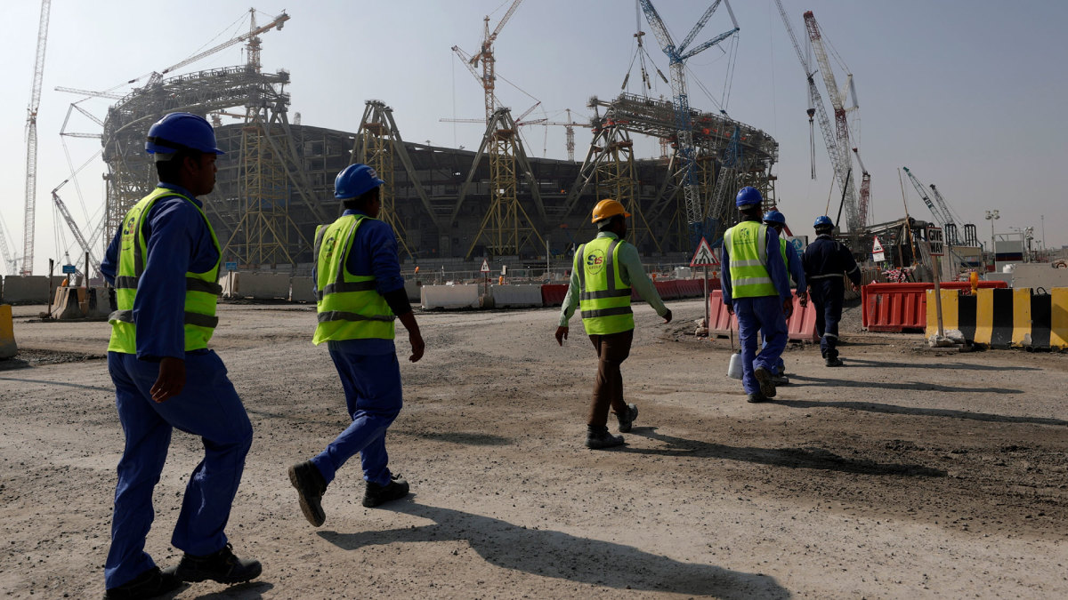 Migrant workers walk to Lusail Stadium in 2019