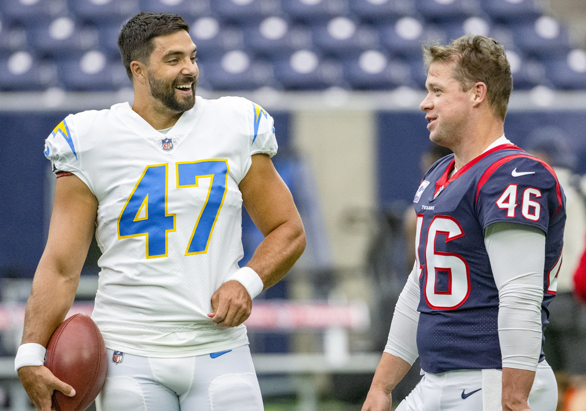 Long snappers Joe Harris of the Chargers and Jon Weeks of the Texans talk before a game.
