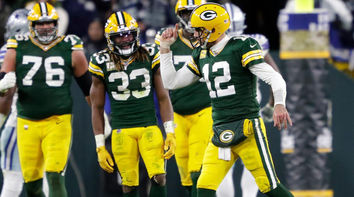 Green Bay Packers quarterback Aaron Rodgers (12) celebrates throwing a touchdown to wide receiver Christian Watson (9) against the Dallas Cowboys during their football game Sunday, November 13, at Lambeau Field in Green Bay, Wis.