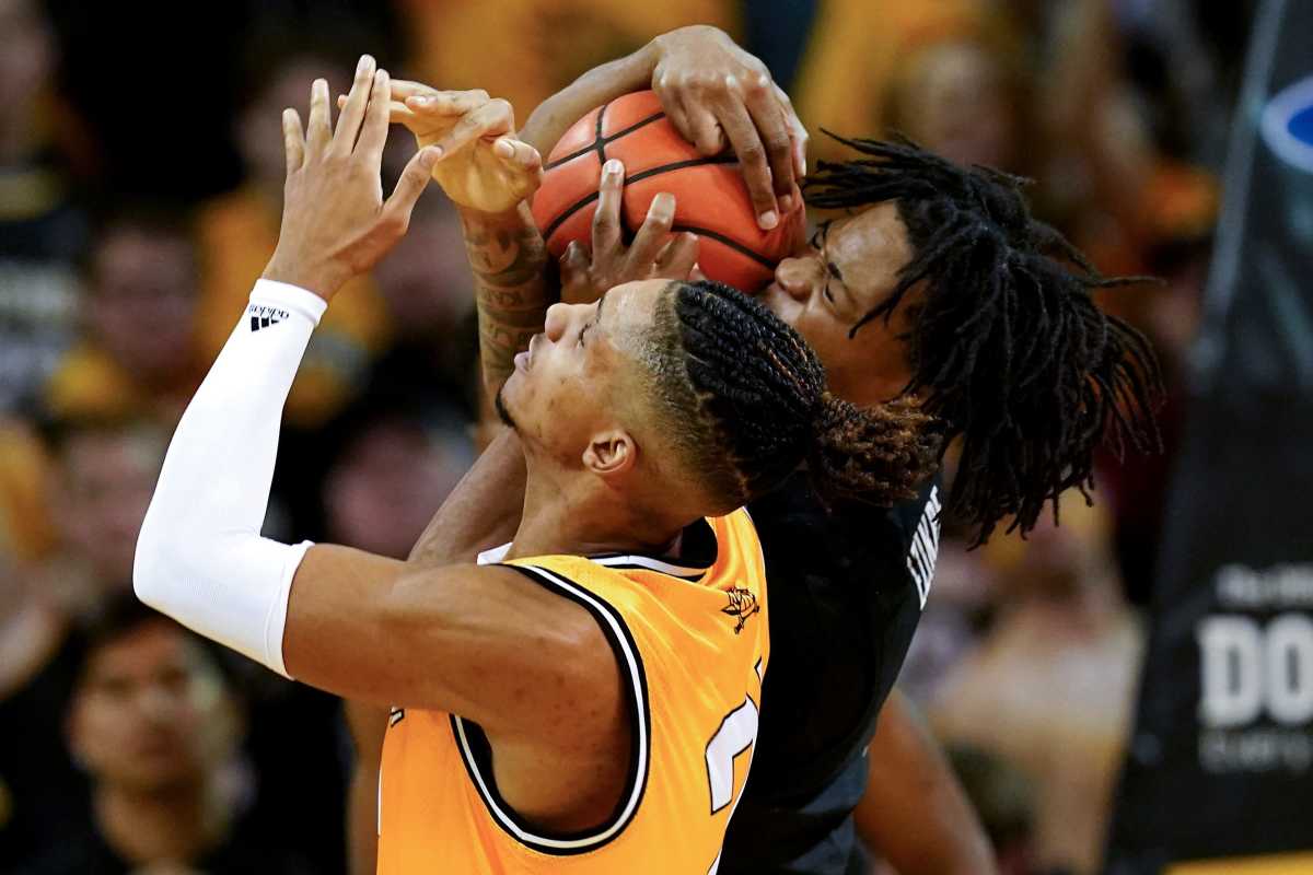 Cincinnati Bearcats forward Kalu Ezikpe (1) and Northern Kentucky Norse forward Chris Brandon (21) compete for a rebound in the first half during a college basketball game, Wednesday, Nov. 16, 2022, at Truist Arena in Highland Heights, Ky. Cincinnati Bearcats At Northern Kentucky Norse Nov 16 0099