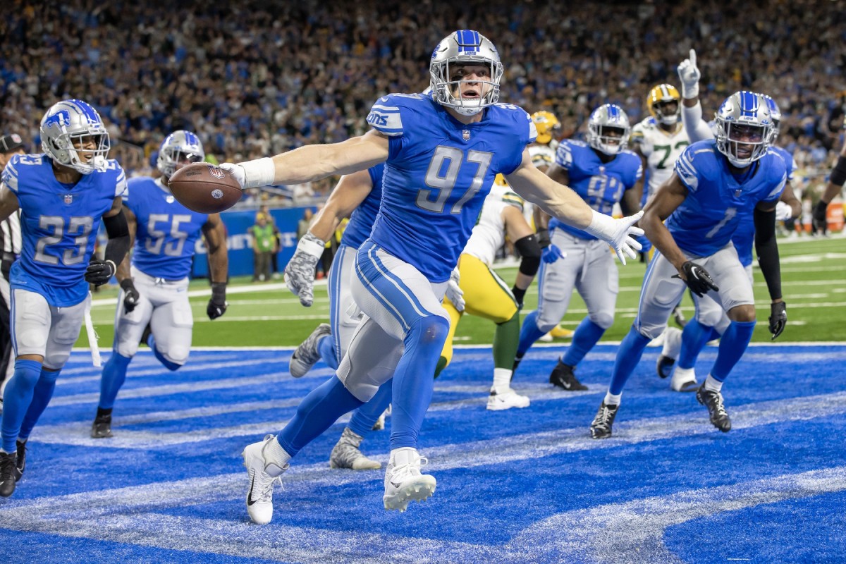 Nov 6, 2022; Detroit, Michigan, USA; Detroit Lions defensive end Aidan Hutchinson (97) celebrates his interception during the second quarter against the Green Bay Packers at Ford Field.
