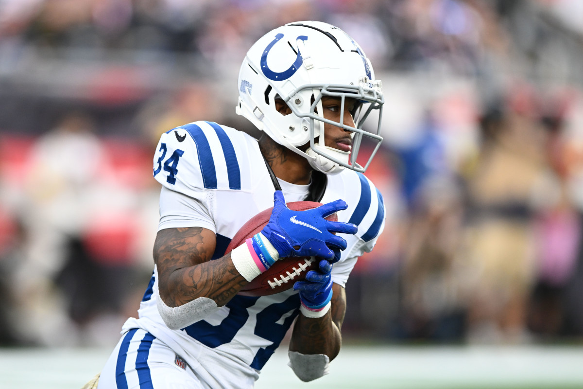 Nov 6, 2022; Foxborough, Massachusetts, USA; Indianapolis Colts cornerback Isaiah Rodgers (34) returns the ball against the New England Patriots during the second half at Gillette Stadium.