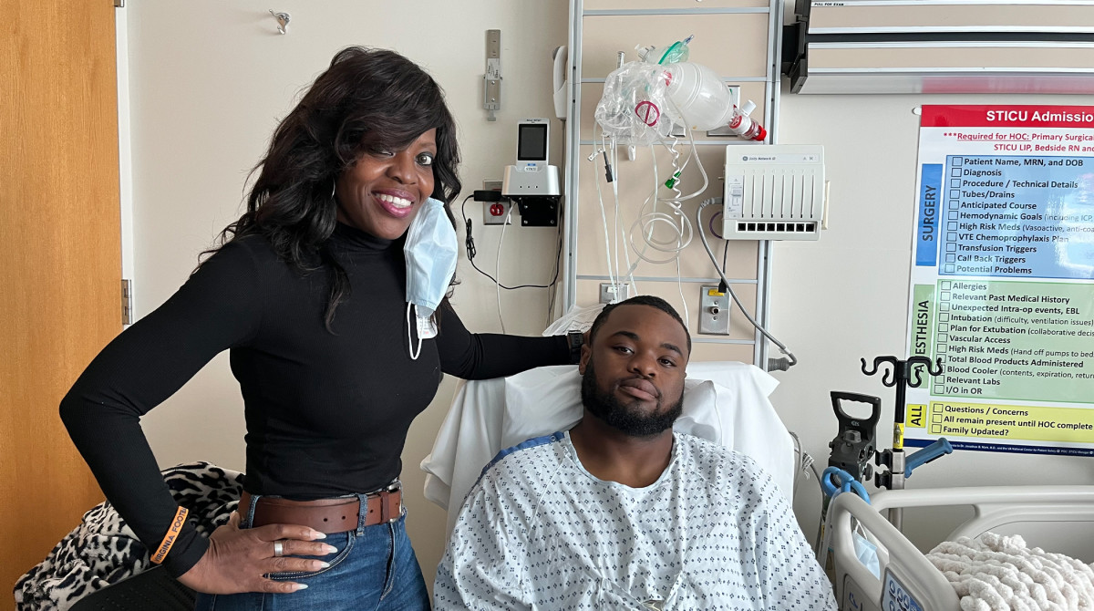 UVA RB Mike Hollins in his hospital bed alongside mom Brenda.