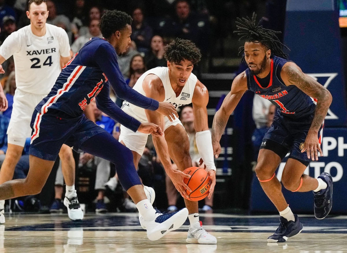 Xavier guard Colby Jones beats two Morgan State players to.a loose ball. (USA TODAY Sports)