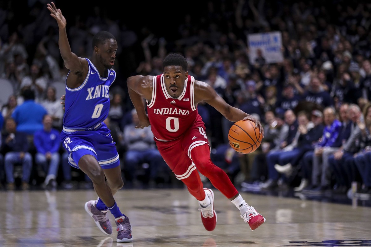 Indiana Hoosiers guard Xavier Johnson (0) dribbles against Xavier Musketeers guard Souley Boum (0) in the first half at Cintas Center.