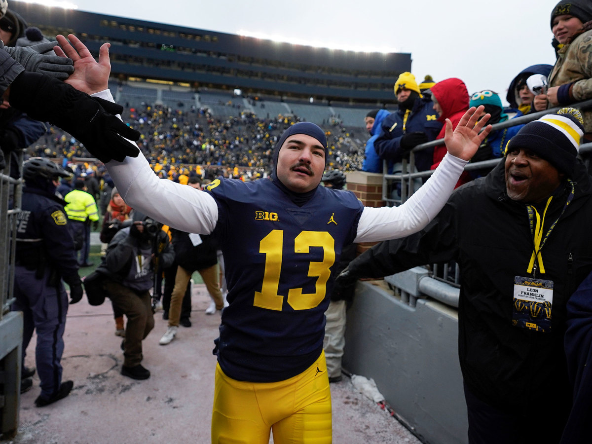 Michigan’s Jake Moody celebrates with fans after beating Illinois