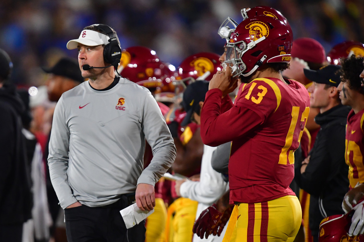 USC coach Lincoln Riley and quarterback Caleb Williams stand on the sidelines