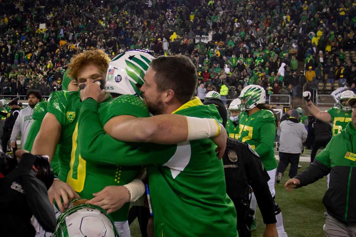 Oregon coach Dan Lanning hugs the team’s quarterback, Bo Nix