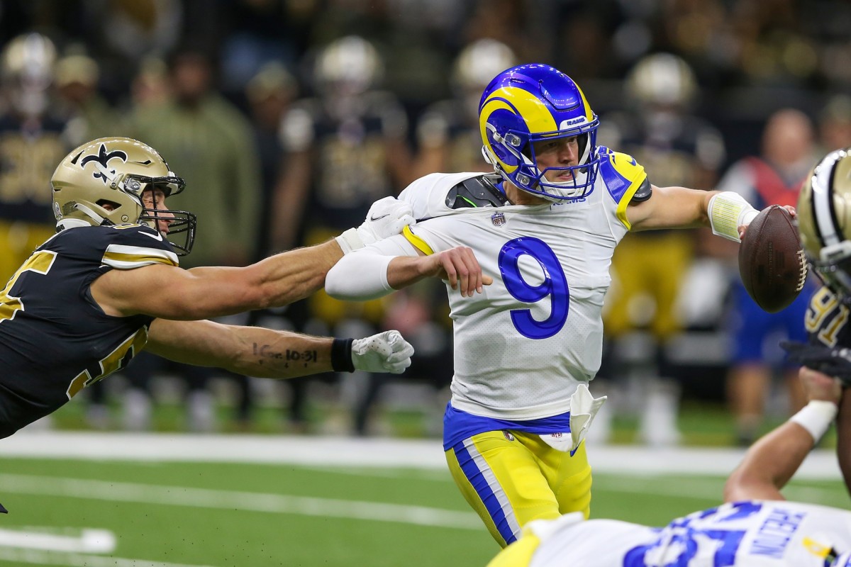 Los Angeles Rams quarterback Matthew Stafford (9) is grabbed by New Orleans Saints linebacker Kaden Elliss (55). Mandatory Credit: Chuck Cook-USA TODAY Sports
