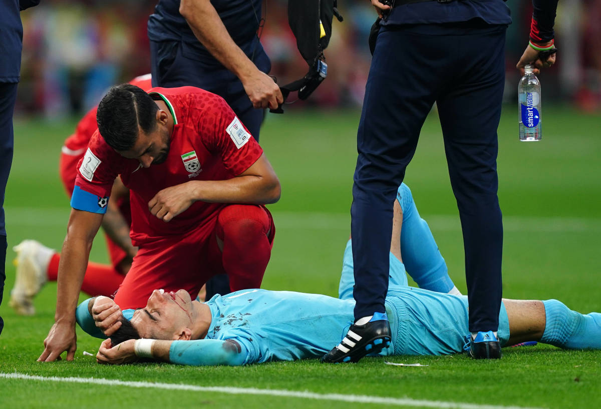 Iran goalkeeper Alireza Beiranvand pictured on the ground after clashing heads with a teammate during his side's 2022 World Cup game against England