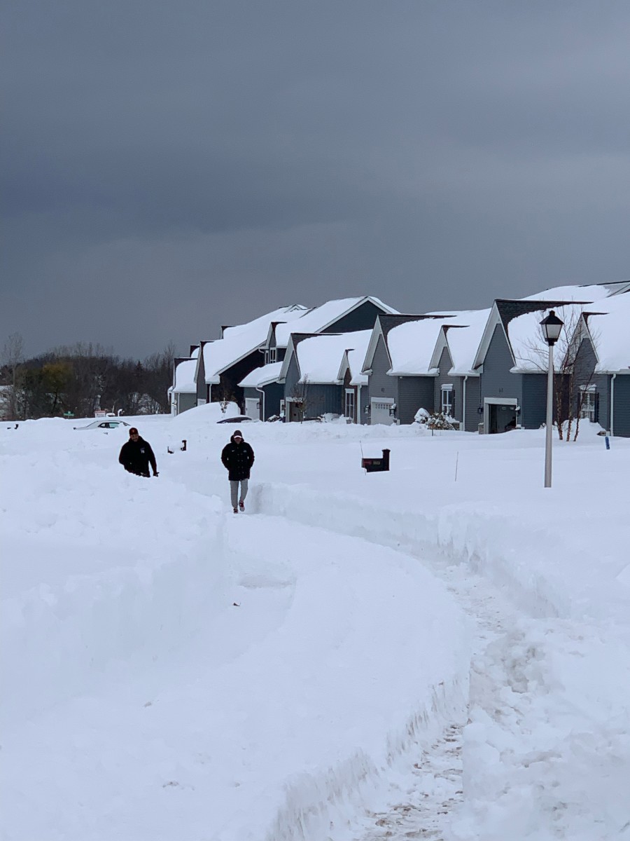 Bills tackle Dion Dawkins walks from his house through a path cleared in the snow