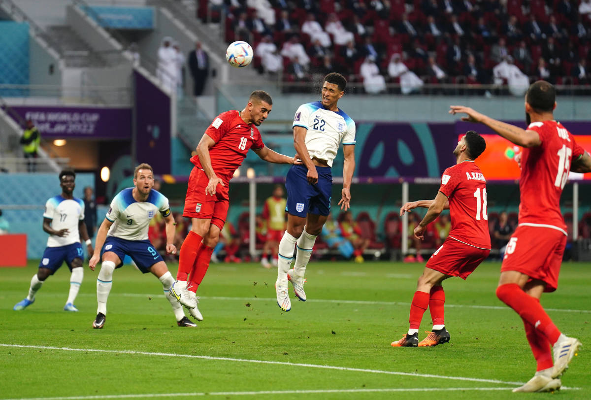 Midfielder Jude Bellingham pictured (center) heading the ball to score England's first goal at the 2022 FIFA World Cup in Qatar