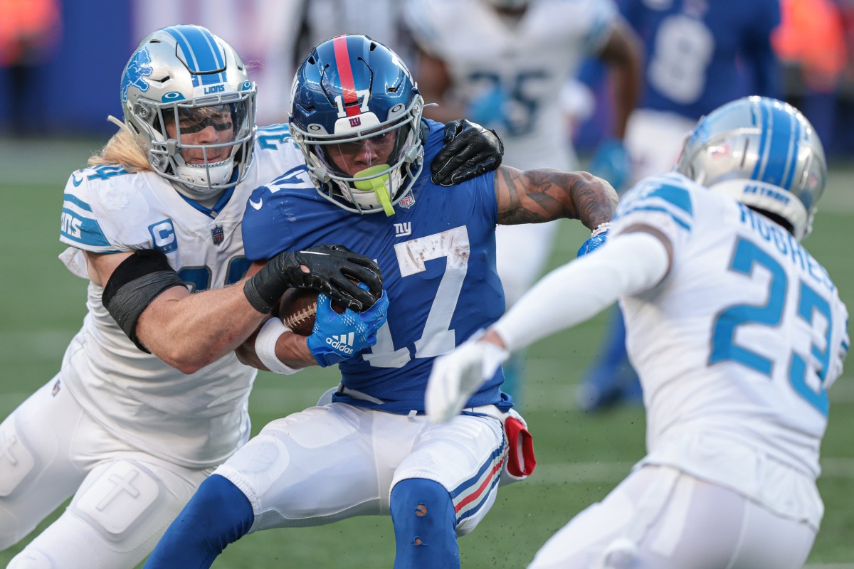 Nov 20, 2022; East Rutherford, New Jersey, USA; New York Giants wide receiver Wan'Dale Robinson (17) breaks a tackle by Detroit Lions linebacker Alex Anzalone (34) in front of cornerback Mike Hughes (23) during the second half at MetLife Stadium.