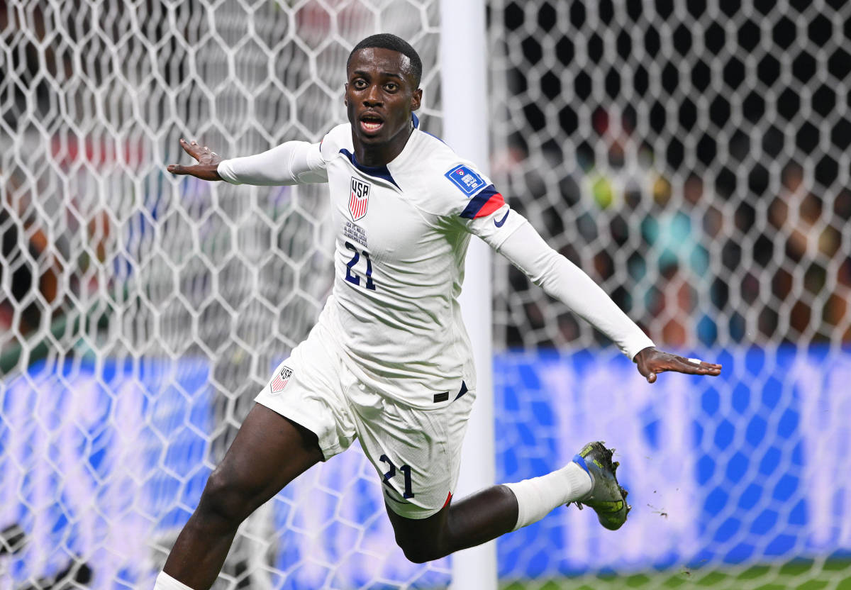 Timothy Weah pictured celebrating after scoring for the USA against Wales at the 2022 FIFA World Cup in Qatar