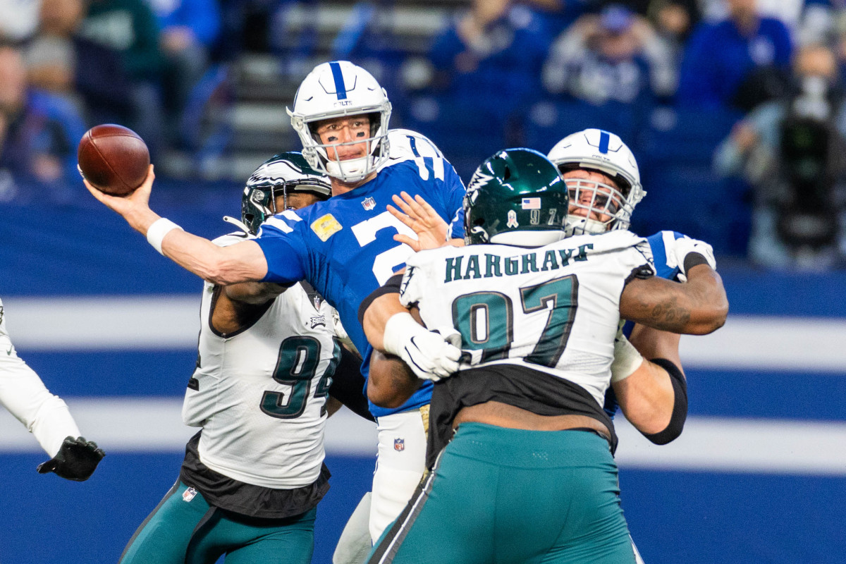 Nov 20, 2022; Indianapolis, Indiana, USA; Indianapolis Colts quarterback Matt Ryan (2) passes the ball while Philadelphia Eagles defensive tackle Javon Hargrave (97) defends in the second quarter at Lucas Oil Stadium. Mandatory Credit: Trevor Ruszkowski-USA TODAY Sports