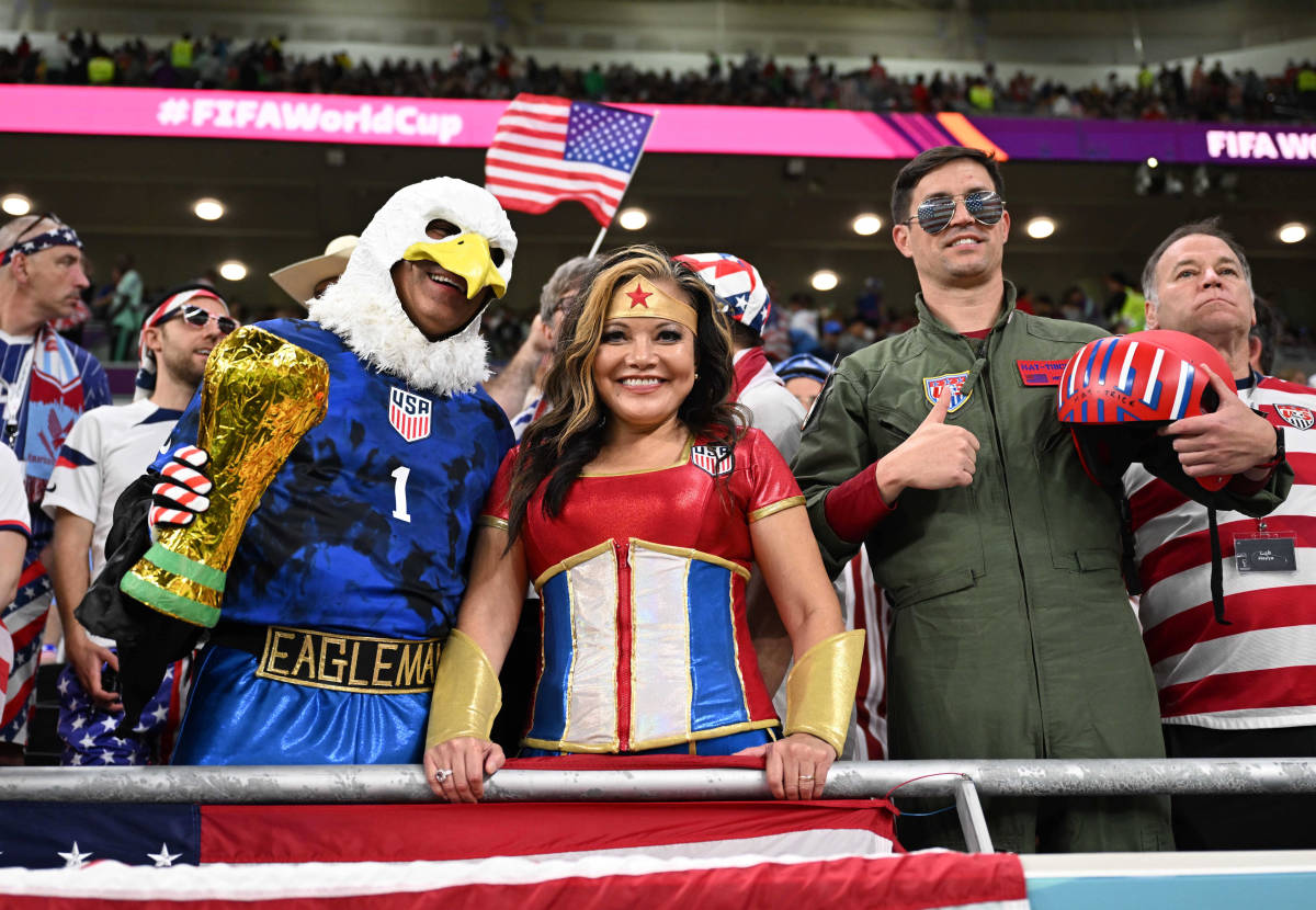 Three fans pictured in fancy dress at the World Cup game between the USA and Wales at Qatar 2022