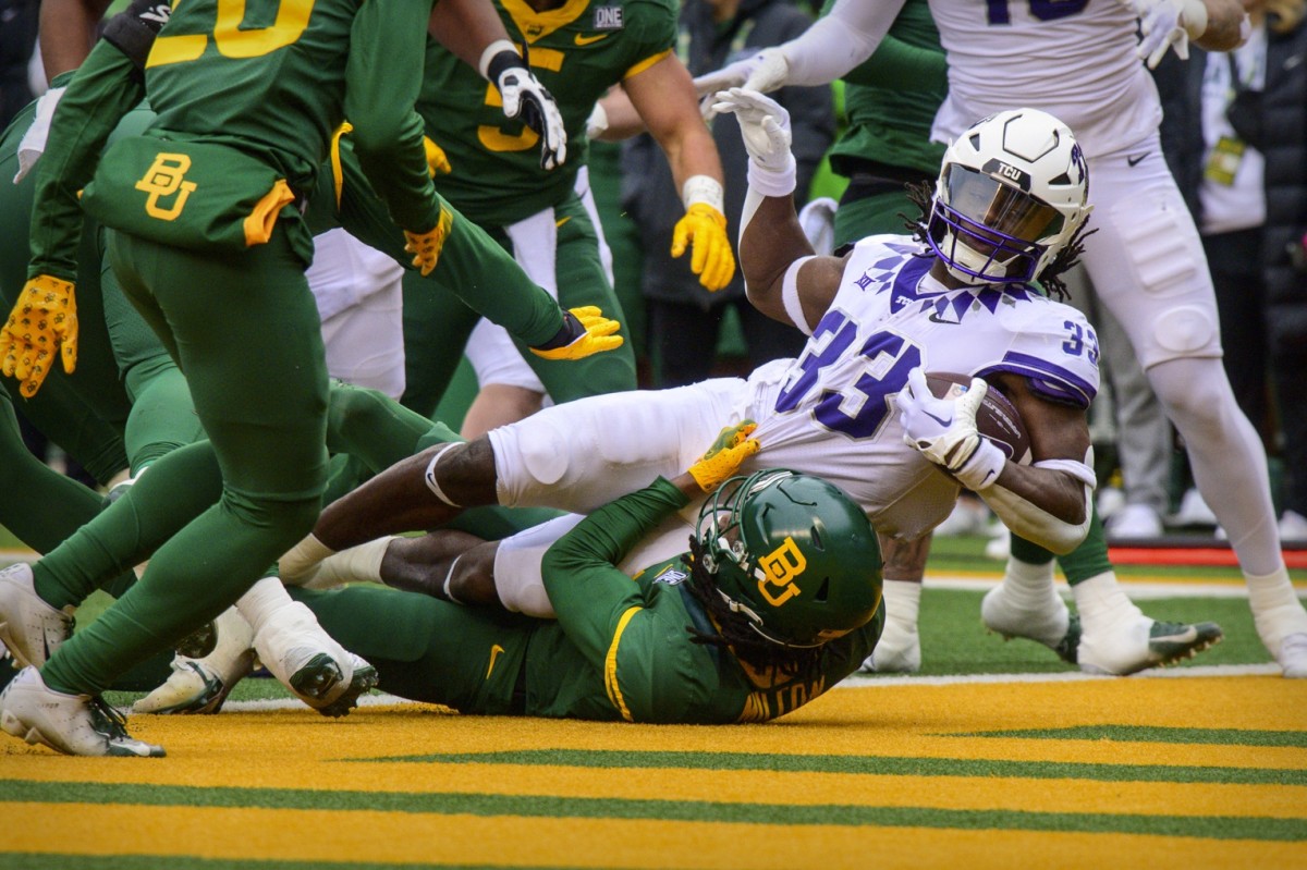 Nov 19, 2022; Waco, Texas, USA; TCU Horned Frogs running back Kendre Miller (33) scores a touchdown against the Baylor Bears during the second quarter at McLane Stadium.