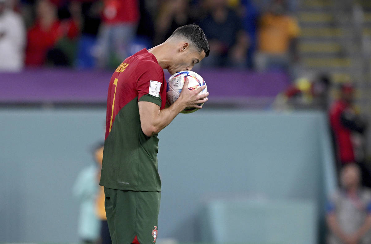Cristiano Ronaldo pictured kissing the ball before converting a penalty against Ghana to score at his fifth FIFA World Cup for Portugal