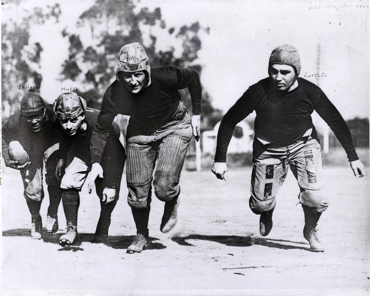 The Akron Pros run hunched over