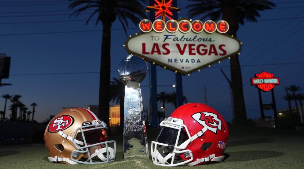 San Francisco 49ers and Kansas City Chiefs helmets with the Lombardi trophy in front of the Welcome to Fabulous Las Vegas sign ahead of Super Bowl LVIII.