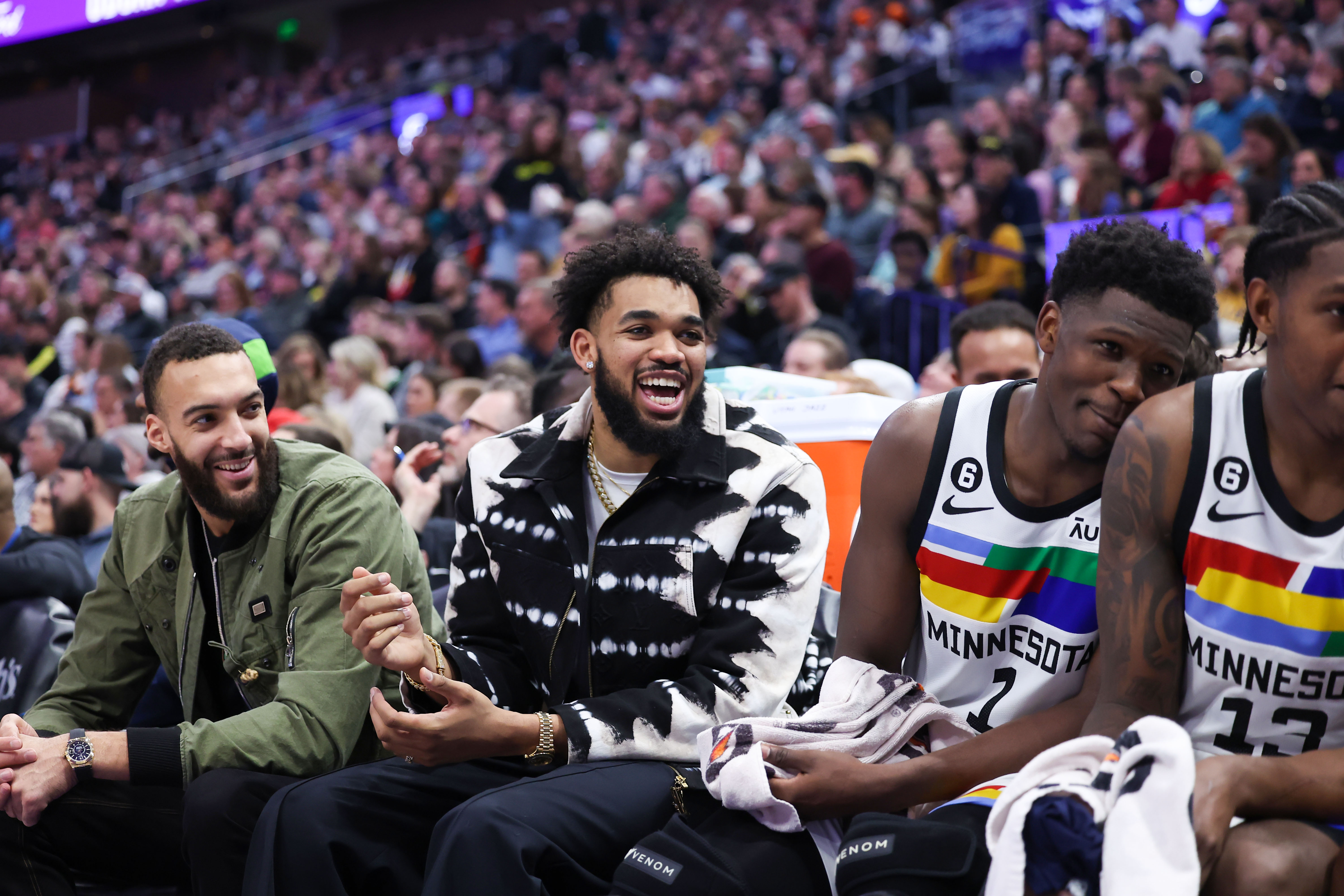 Rudy Gobert, Karl-Anthony Towns and Anthony Edwards laugh on the bench