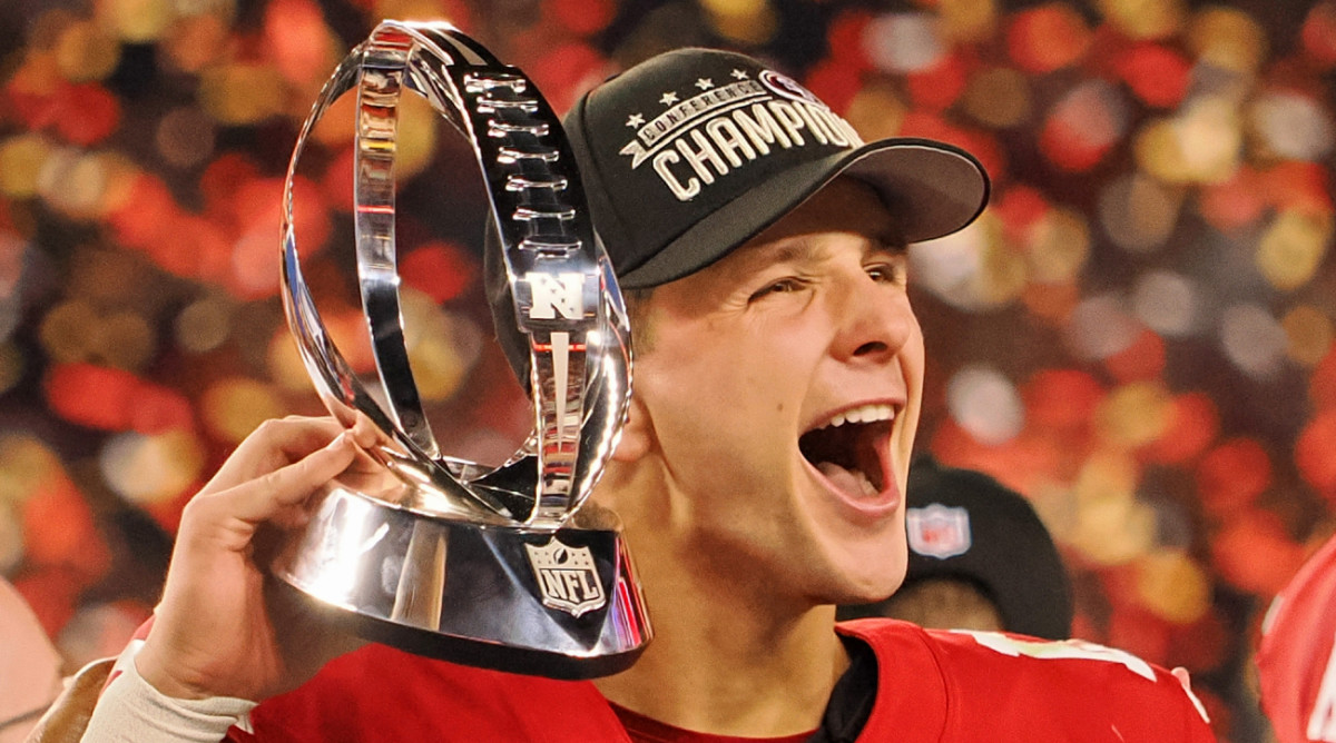 49ers quarterback Brock Purdy celebrates with the George Halas Trophy after the team won the 2023 NFC championship.