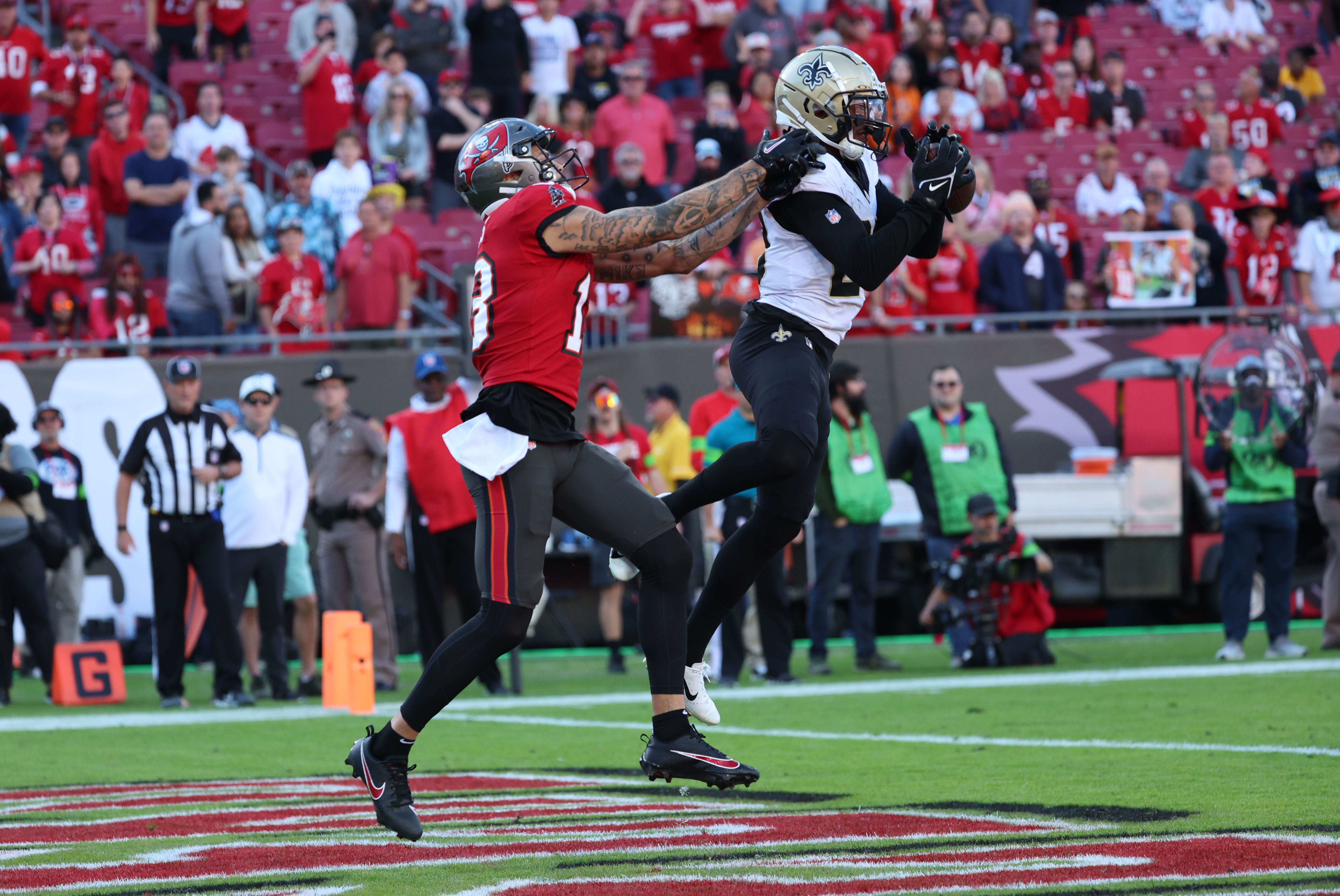 Dec 31, 2023; Tampa, Florida, USA; New Orleans Saints cornerback Paulson Adebo (29) intercepted the ball for the 2-point conversion over Tampa Bay Buccaneers wide receiver Mike Evans (13) during the second half at Raymond James Stadium. Mandatory Credit: Kim Klement Neitzel-USA TODAY Sports