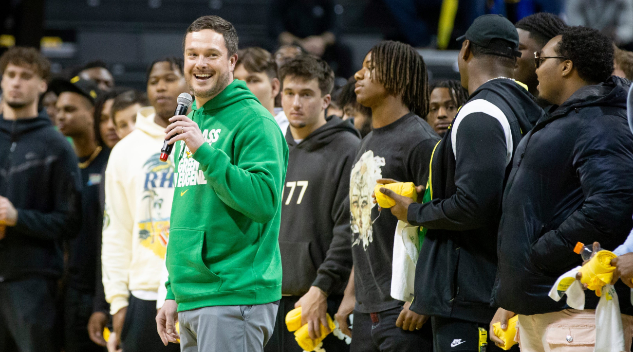 Dan Lanning and the Oregon Ducks football team addresses the crowd at a basketball game.