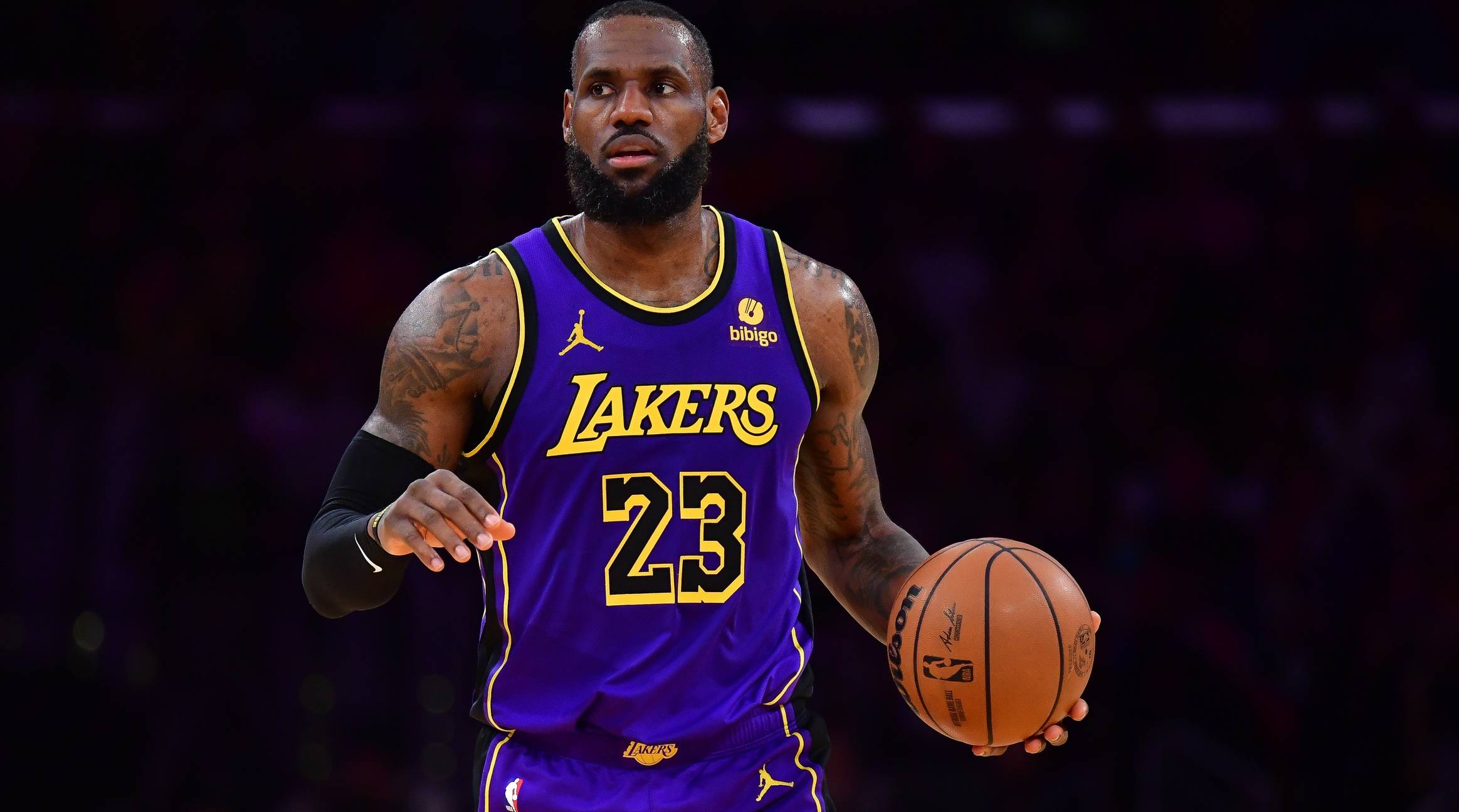 Lakers forward LeBron James dribbles a ball in a game.