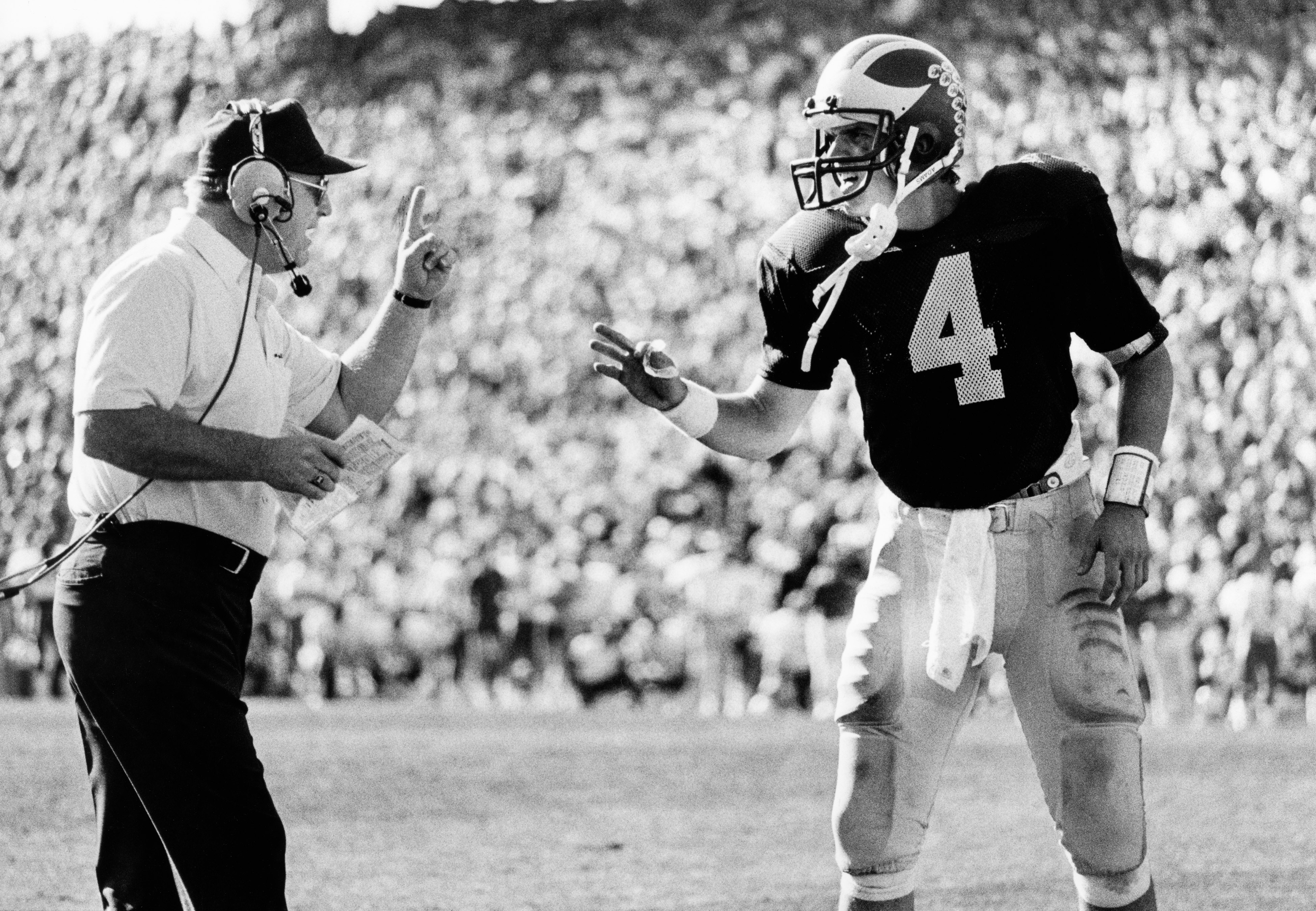 Michigan quarterback Jim Harbaugh speaks with Bo Schembechler during the 1986 Fiesta Bowl.