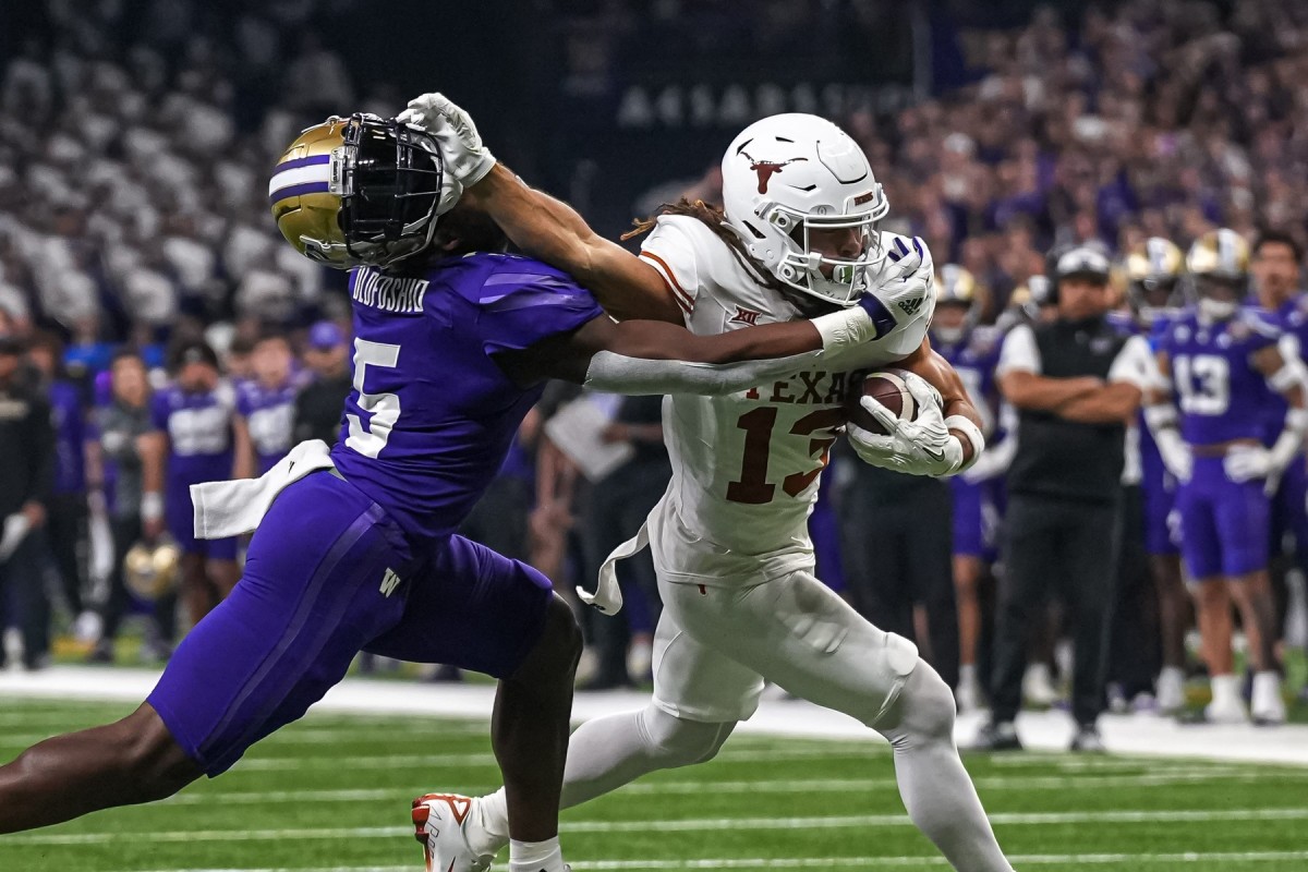 Texas Longhorns wide receiver Jordan Whittington (13) breaks a tackle by Washington linebacker Edefuan Ulofoshio (5) during the Sugar Bowl College Football Playoff semifinals game at the Caesars Superdome on Monday, Jan. 1, 2024 in New Orleans, Louisiana.  